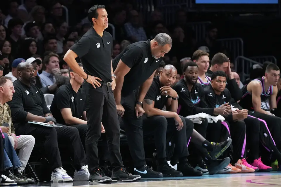 Miami Heat head coach Erik Spoelstra, left watches during the second half of an NBA basketball game against the San Antonio Spurs, Monday, March 23, 2026, in Miami. (AP Photo/Lynne Sladky)