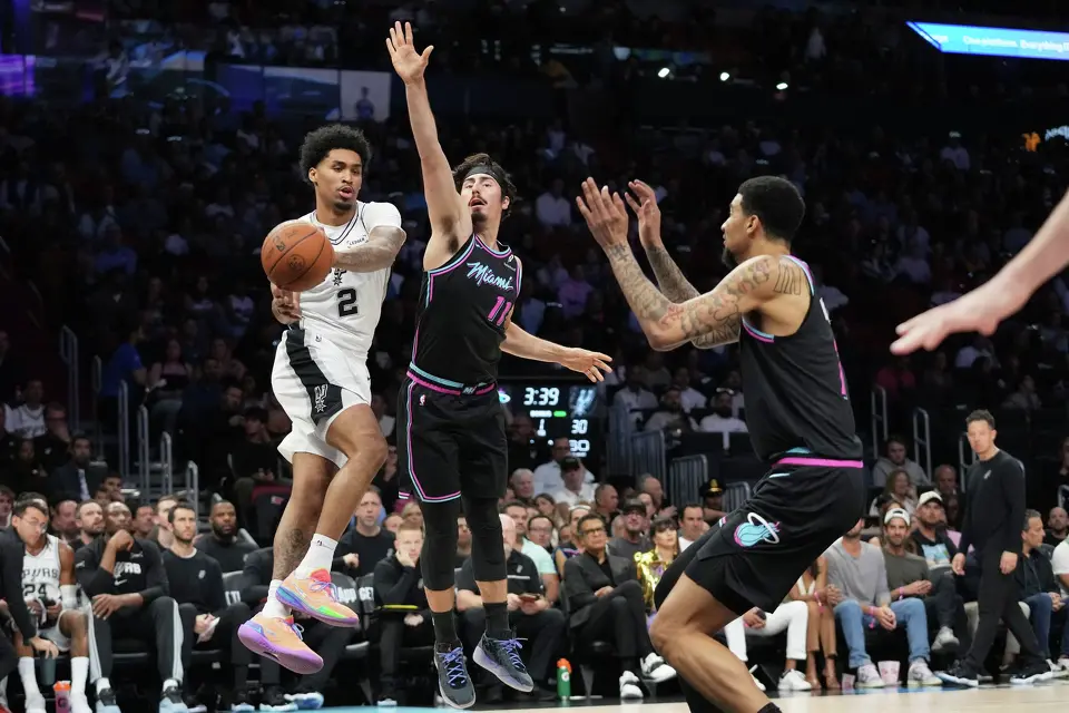 San Antonio Spurs guard Dylan Harper (2) looks to pass as Miami Heat forward Jaime Jaquez Jr. (11) defends during the first half of an NBA basketball game, Monday, March 23, 2026, in Miami. (AP Photo/Lynne Sladky)