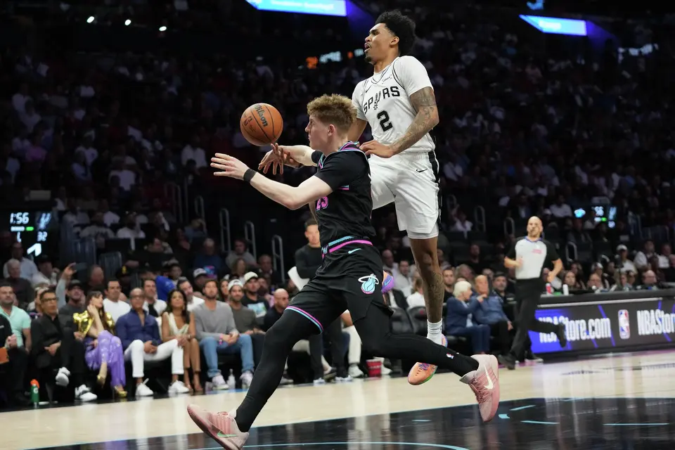 San Antonio Spurs guard Dylan Harper (2) drives to the basket as Miami Heat guard Kasparas Jakucionis, left, defends during the first half of an NBA basketball game, Monday, March 23, 2026, in Miami. (AP Photo/Lynne Sladky)