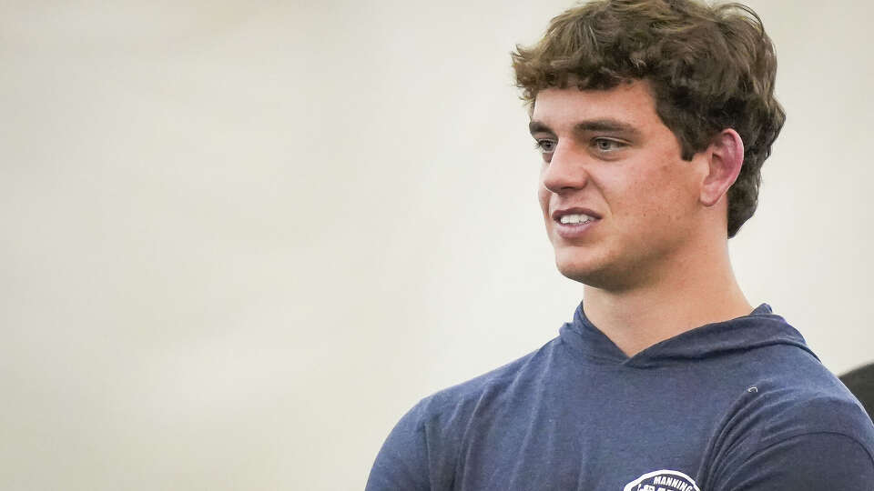 Texas quarterback Arch Manning watches his former teammates during Texas Longhorns pro day on campus at the University of Texas, March 24, 2026.