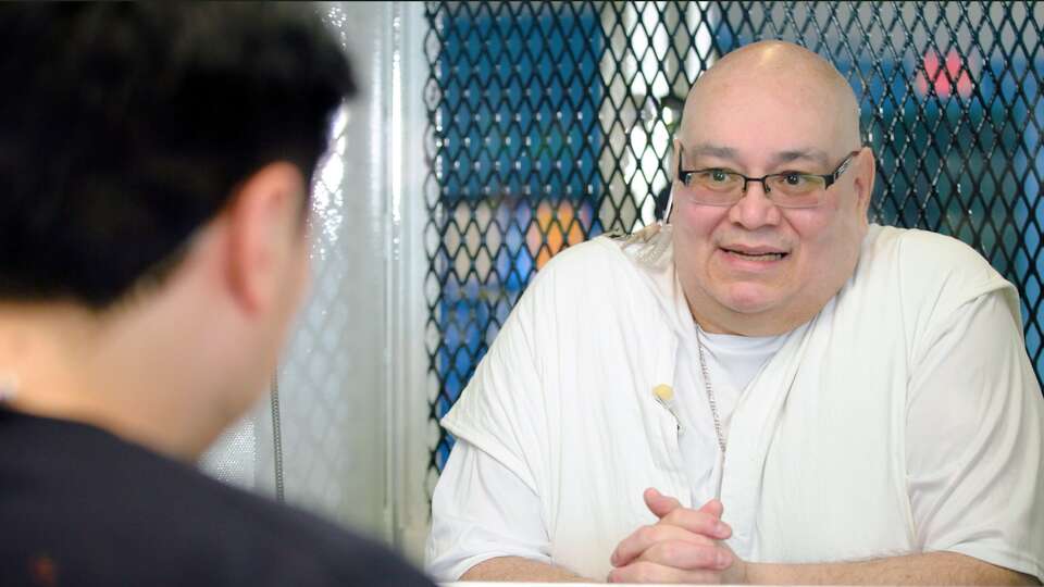 Podcaster Pablo Torres speaks with death-row inmate Charles Flores at the supermax Polunsky Unit in Livingston.