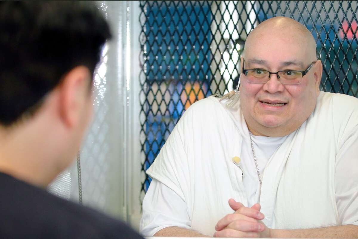 Podcaster Pablo Torres speaks with death-row inmate Charles Flores at the supermax Polunsky Unit in Livingston.