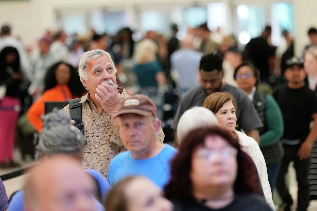Passengers wait in a security checkpoint line at George Bush Intercontinental Airport, Wednesday, March 25, 2026, in Houston.