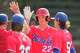Bennet School’s Karson Reeder gets high-fives after scoring on J.T. Durden’s RBI double during a high school sports academy baseball game in Houston, Wednesday, March 25, 2026.