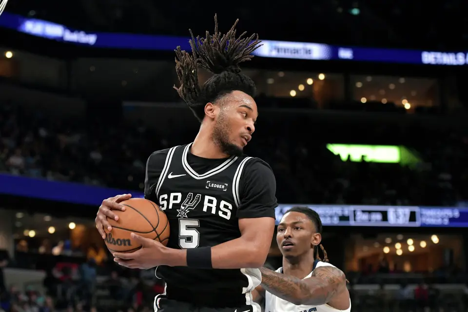 San Antonio Spurs guard Stephon Castle (5) handles the ball against Memphis Grizzlies guard Javon Small in the first half of an NBA basketball game Wednesday, March 25, 2026, in Memphis, Tenn. (AP Photo/Brandon Dill)
