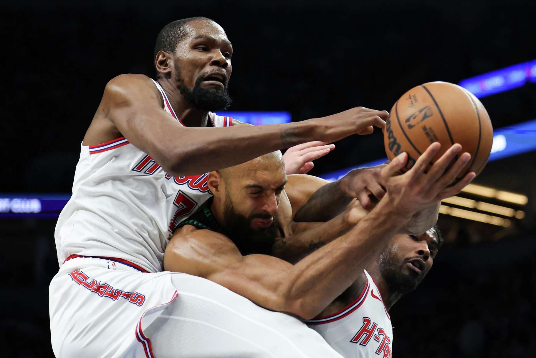 Houston Rockets forward Kevin Durant (7), Minnesota Timberwolves center Rudy Gobert, center, and Houston Rockets guard Amen Thompson, right, compete for a rebound during the first half of an NBA basketball game, Wednesday, March 25, 2026, in Minneapolis. (AP Photo/Ellen Schmidt)