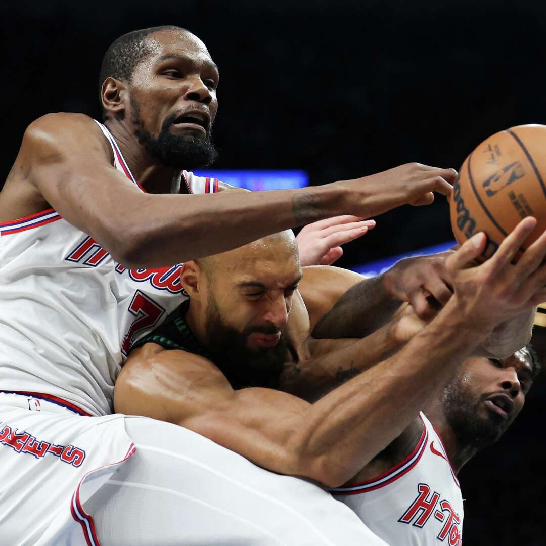 Houston Rockets forward Kevin Durant (7), Minnesota Timberwolves center Rudy Gobert, center, and Houston Rockets guard Amen Thompson, right, compete for a rebound during the first half of an NBA basketball game, Wednesday, March 25, 2026, in Minneapolis. (AP Photo/Ellen Schmidt)