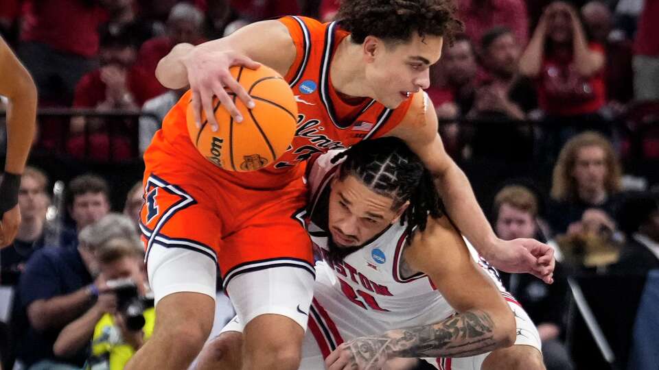 Illinois guard Keaton Wagler (23) brings the ball up the court as Houston Cougars guard Emanuel Sharp (21) leans in to defend during the second half of a South Regional semifinal in NCAA college basketball tournament in Houston, Thursday, March 26, 2026.