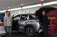 Visitors walk by a hybrid car at a BYD showroom in Beijing, China, Thursday, March 26, 2026.