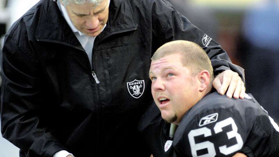 Oakland Raiders center Barret Robbins listens to coaching from the bench during a preseason game on Aug. 24, 2002. (Photo by Ray Chavez/MediaNews Group/Alameda Newspaper Group via Getty Images)