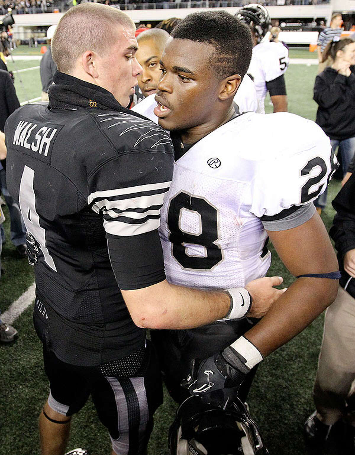 Guyer quarterback J.W. Walsh (left) and Steele's Malcolm Brown talk after the Class 5A Division II state final.