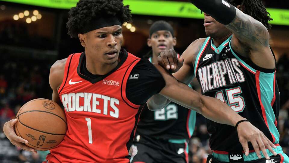 Houston Rockets guard Amen Thompson (1) handles the ball against Memphis Grizzlies forward GG Jackson II (45) in the first half of an NBA basketball game Friday, March 27, 2026, in Memphis, Tenn. (AP Photo/Brandon Dill)