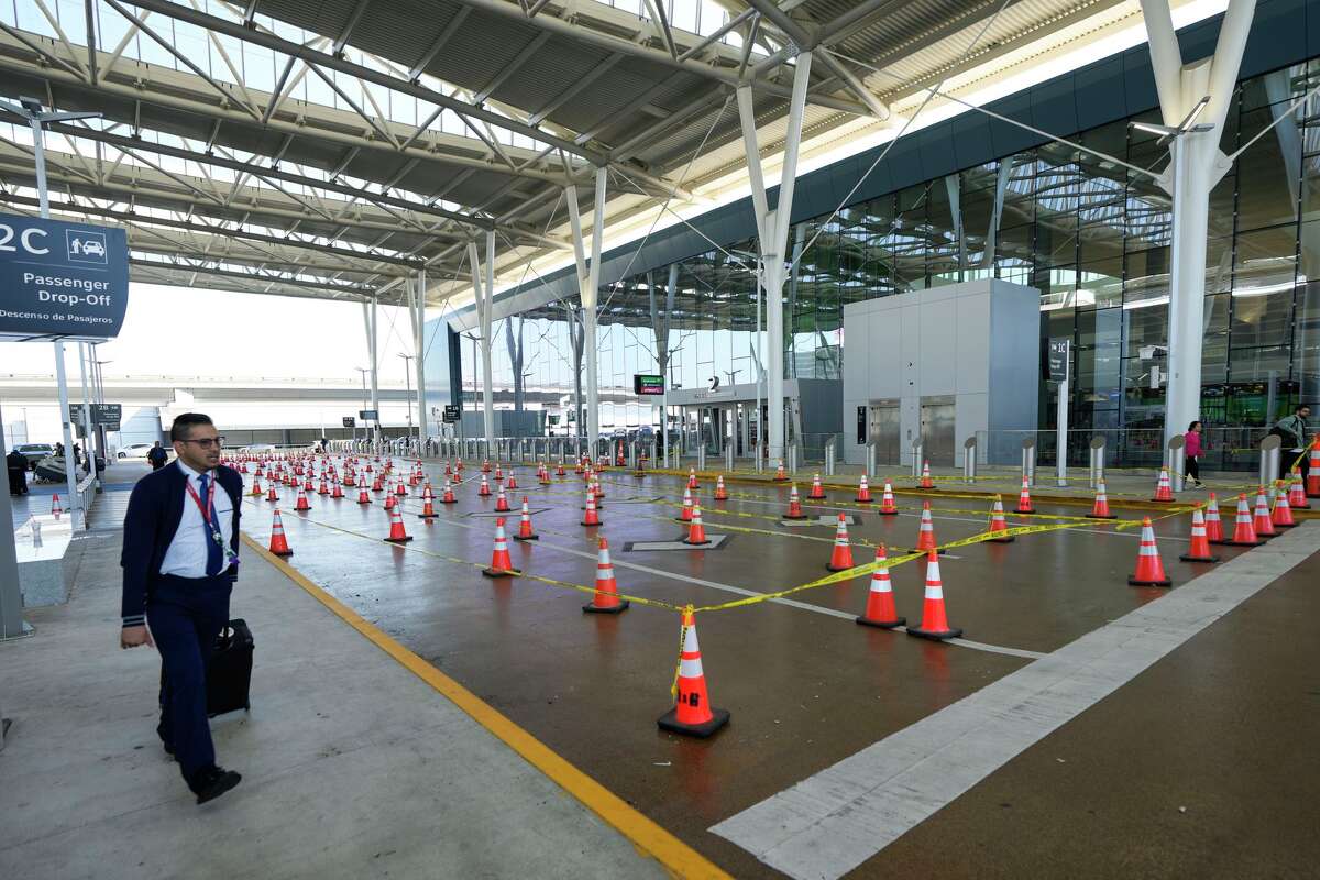 Airline passengers make their way to the security lines in Terminal E at George Bush Intercontinental Airport in Houston, Sunday, March 29, 2026. The outdoor line at IAH was empty Sunday morning.