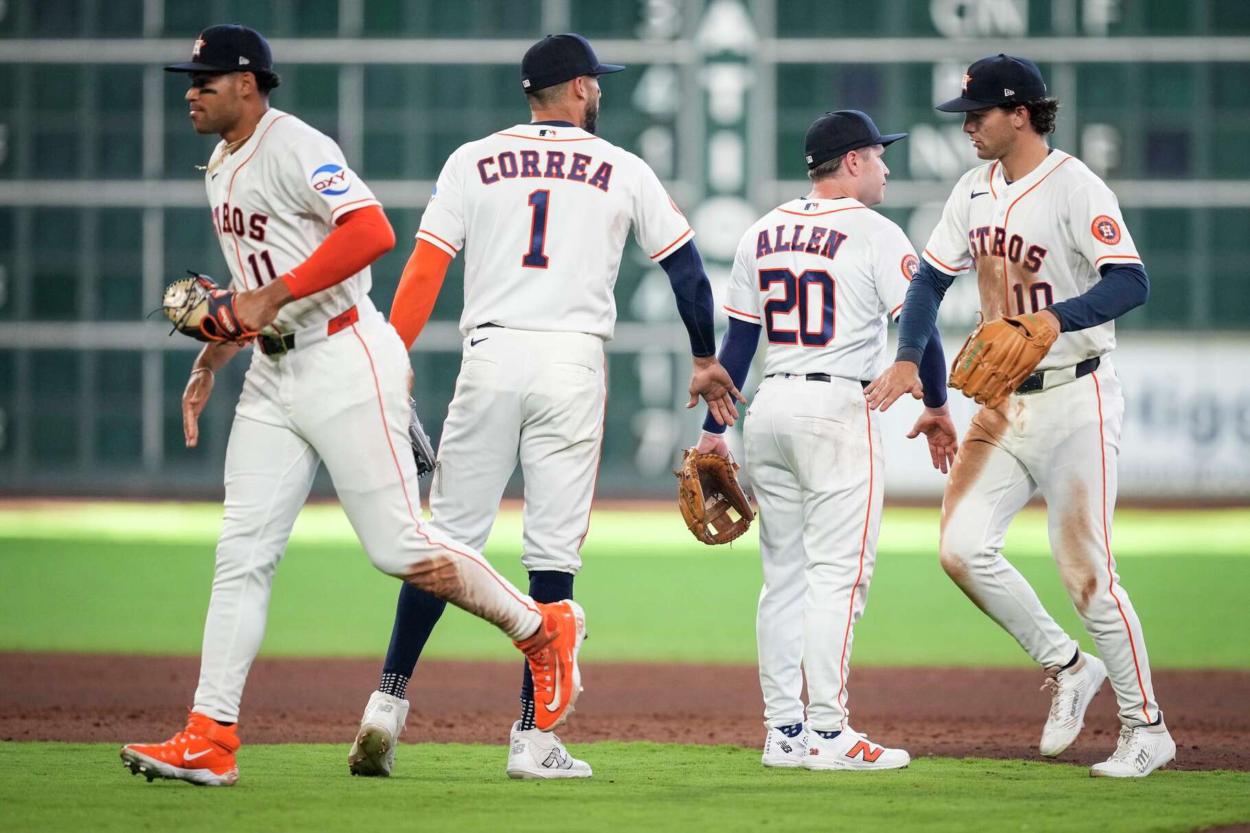 Houston Astros Cam Smith (11), Carlos Correa (1), Nick Allen (20) and Joey Loperfido (10) high five after a 9-7 win over the Los Angeles Angels in a Major League Baseball game at Daikin Park in Houston, Sunday, March 29, 2026.