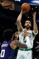 Boston Celtics forward Jayson Tatum, right, passes over Charlotte Hornets forward Miles Bridges during the second half of an NBA basketball game in Charlotte, N.C., Sunday, March 29, 2026.