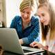 Mother and daughter on laptop in the kitchen, leaning about Pearson's Connections Academy AI policy for responsible AI use to help her child become a confident, adaptable, lifelong learner.
