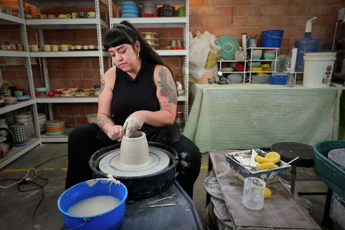 Lori Muñoz works on the potters wheel her pottery studio in Houston, Monday, March 30, 2026. Muñoz is an emerging pottery artist who's made plates served at a growing number of local restaurants.