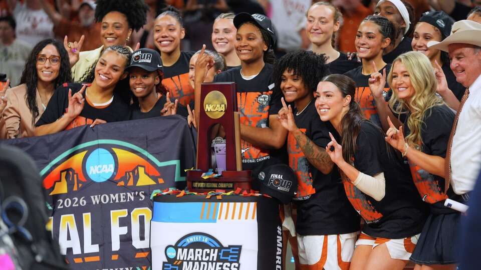 Texas players pose after beating Michigan in the Elite Eight of the NCAA college basketball tournament, Monday, March 30, 2026, in Fort Worth, Texas. (AP Photo/LM Otero)