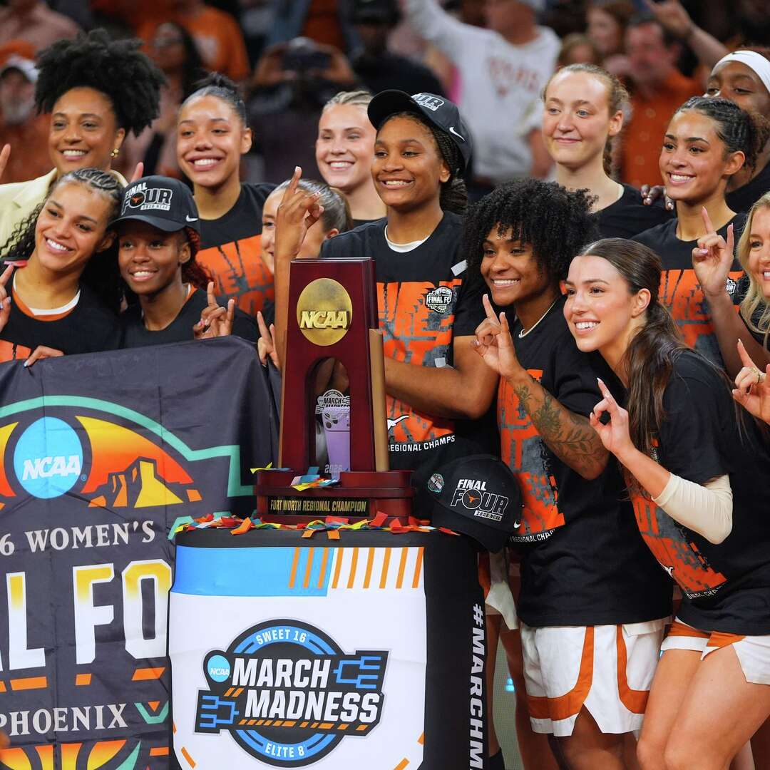 Texas players pose after beating Michigan in the Elite Eight of the NCAA college basketball tournament, Monday, March 30, 2026, in Fort Worth, Texas. (AP Photo/LM Otero)