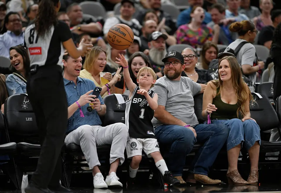 A young San Antonio Spurs fan throws the ball to referee Danielle Scott (87) during the second half of an NBA basketball game against the Chicago Bulls, Monday, March 30, 2026, in San Antonio. (AP Photo/Darren Abate)