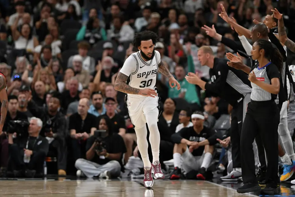 San Antonio Spurs forward Julian Champagnie (30) celebrates after a 3-point basket during the second half of an NBA basketball game against the Chicago Bulls, Monday, March 30, 2026, in San Antonio. (AP Photo/Darren Abate)