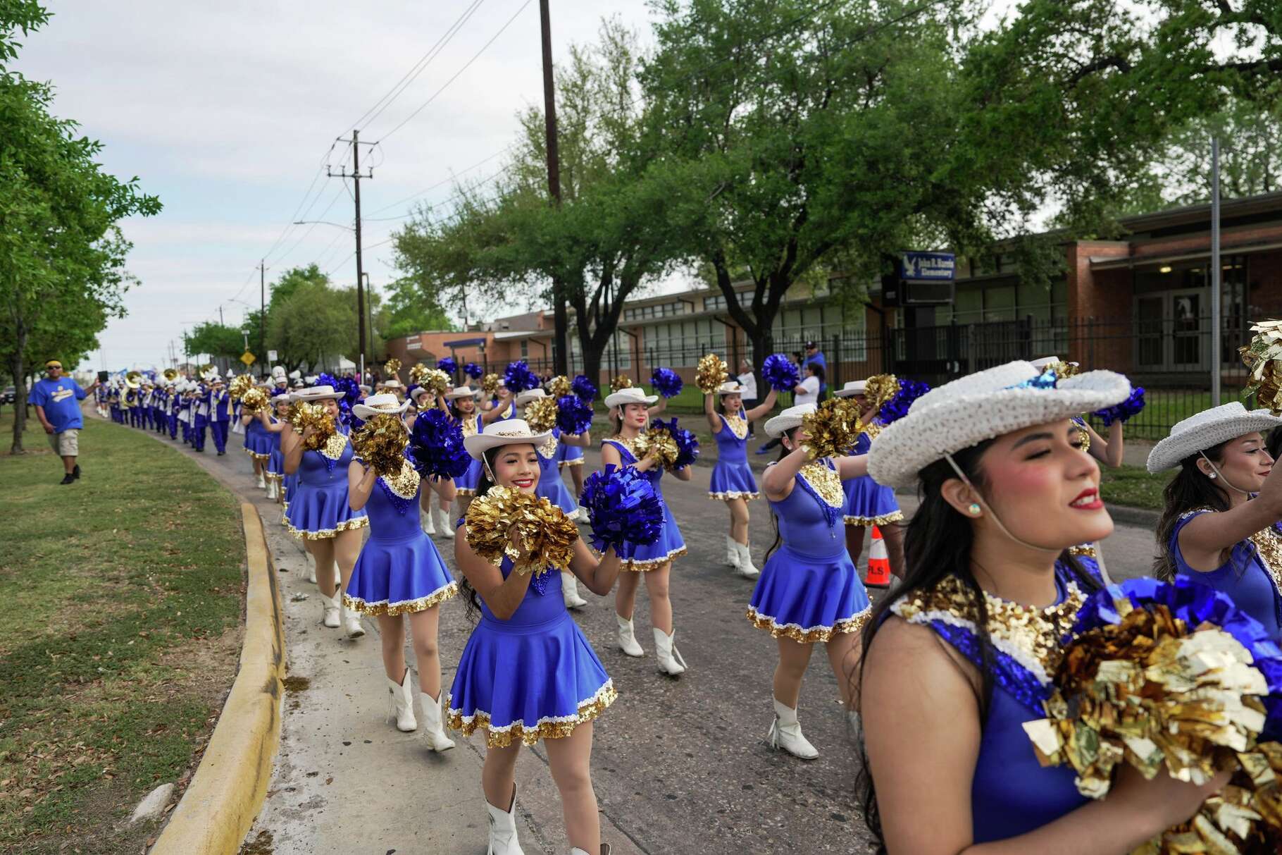 Students and alumni march from J.R. Harris Elementary School to Milby High School to commemorate the school’s 100th anniversary in Houston, Saturday, March 28, 2026.