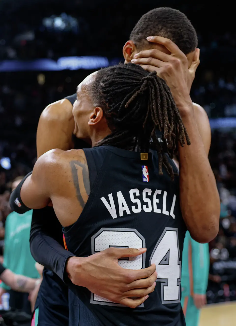 San Antonio Spurs guard Devin Vassell (24) embraces San Antonio Spurs forward Victor Wembanyama (1) as they celebrate their 116-112 comeback victory over the LA Clippers at Frost Bank Center in San Antonio, Friday, March 6, 2026.