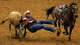 Royce Johnson of of Nemaha, NE wrestles a steer after sliding off his horse at the opening weekend of the Mesquite ProRodeo held in the Resistol Arena, Saturday, June 1, 2013.