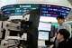 Currency traders watch monitors near a screen showing the Korea Composite Stock Price Index (KOSPI), top center, and the foreign exchange rate between U.S. dollar and South Korean won, top center left, at the foreign exchange dealing room of the Hana Bank headquarters in Seoul, South Korea, Wednesday, April 1, 2026.