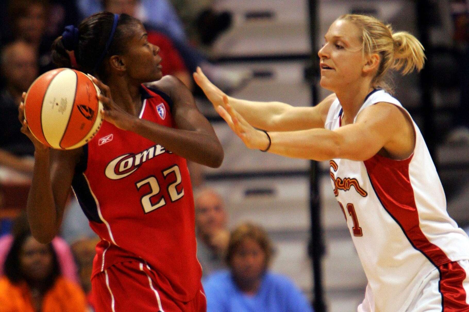 The Houston Comets' Sheryl Swoopes looks for a teammate to pass to as the Connecticut Sun's Brooke Wyckoff defends in the second half of the Sun-Comets WNBA game in Uncasville, Conn., Friday, July 15, 2005. More than 20 years later, the Connecticut Sun are moving to Houston and will be rebranded as the Comets.