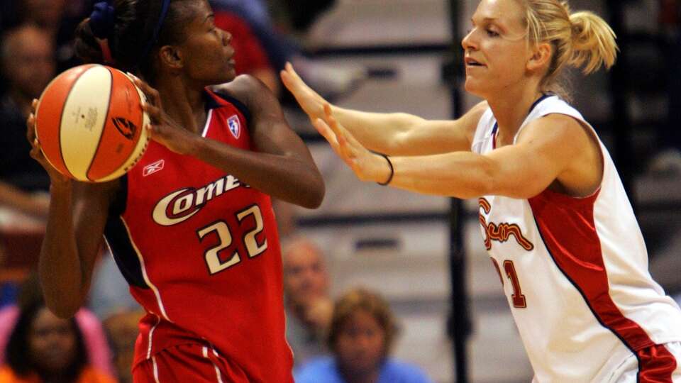 The Houston Comets' Sheryl Swoopes looks for a teammate to pass to as the Connecticut Sun's Brooke Wyckoff defends in the second half of the Sun-Comets WNBA game in Uncasville, Conn., Friday, July 15, 2005. More than 20 years later, the Connecticut Sun are moving to Houston and will be rebranded as the Comets.