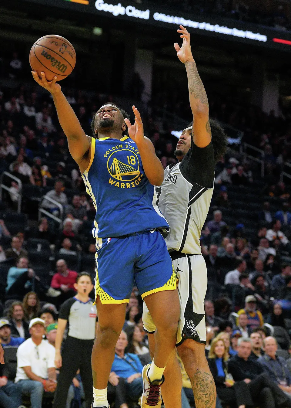 Golden State Warriors guard Lj Cryer (18) drives to the basket against San Antonio Spurs guard Dylan Harper, right, during the second half of an NBA basketball game in San Francisco, Wednesday, April 1, 2026. (AP Photo/Tony Avelar)
