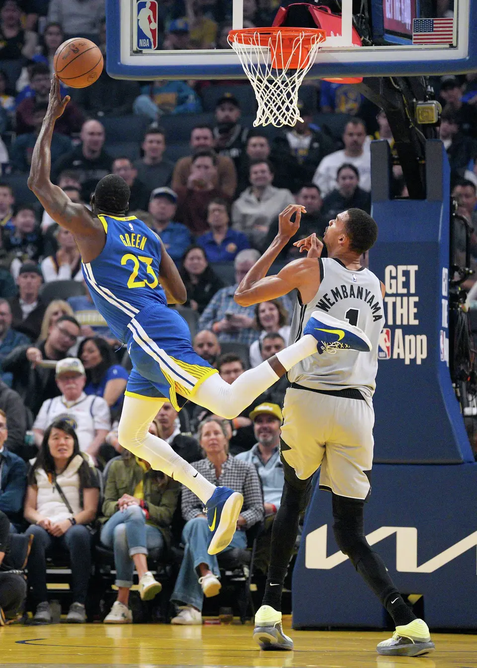 Golden State Warriors forward Draymond Green (23) drives to the basket against San Antonio Spurs forward Victor Wembanyama (1) during the first half of an NBA basketball game in San Francisco, Wednesday, April 1, 2026. (AP Photo/Tony Avelar)