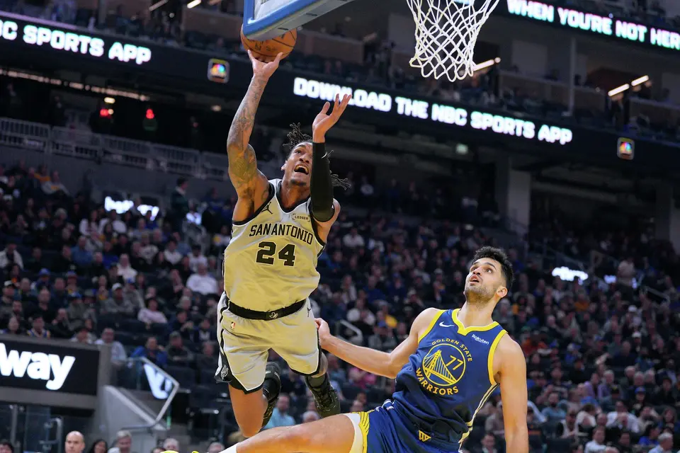 San Antonio Spurs guard Devin Vassell (24) reacts as he is fouled by Golden State Warriors center Omer Yurtseven (77) during the first half of an NBA basketball game in San Francisco, Wednesday, April 1, 2026. (AP Photo/Tony Avelar)