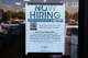A now hiring sign sits on the window of a retail clothing store in Garland, Texas, Monday, March 23, 2026.