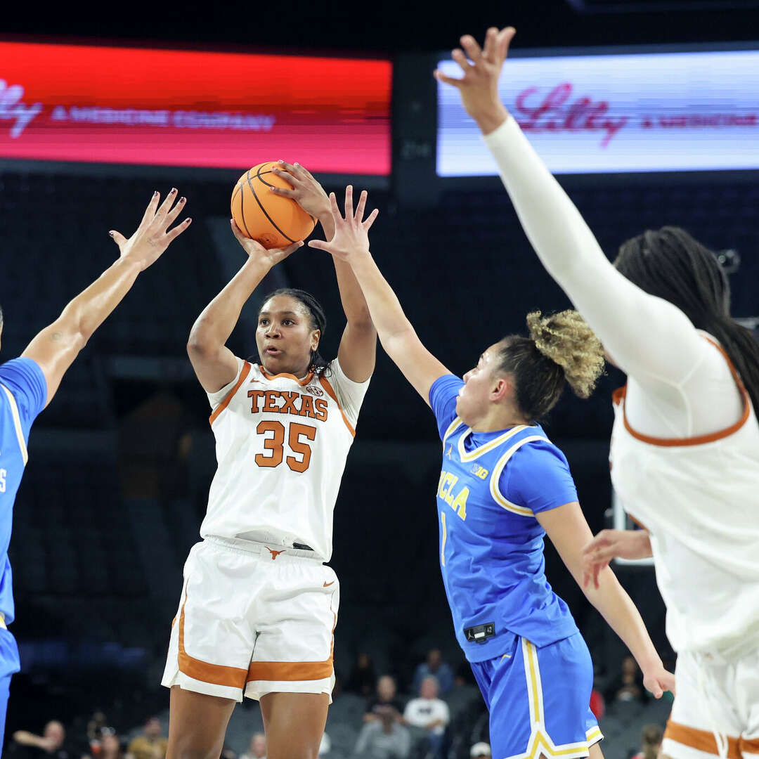 Madison Booker of the Texas Longhorns shoots against Lauren Betts (51) and Kiki Rice (1) of the UCLA Bruins during the first quarter of a Players Era Championship basketball tournament game at Michelob Ultra Arena on November 26, 2025 in Las Vegas, Nevada.