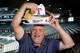 Dallas Morning News Texas Rangers reporter Evan Grant dips a chip from the loaded 9th Inning Sombrero during a taste test of the Rangers new concession options at Globe Life Field in Arlington, April 2, 2026. The 26-inch fried tortilla shell is filled with refried beans, cheddar cheese, sour cream, guacamole, pico de gallo, black olives, jalapeños and shredded lettuce served with tortilla chips. Evan doesn’t recommend you wear it.