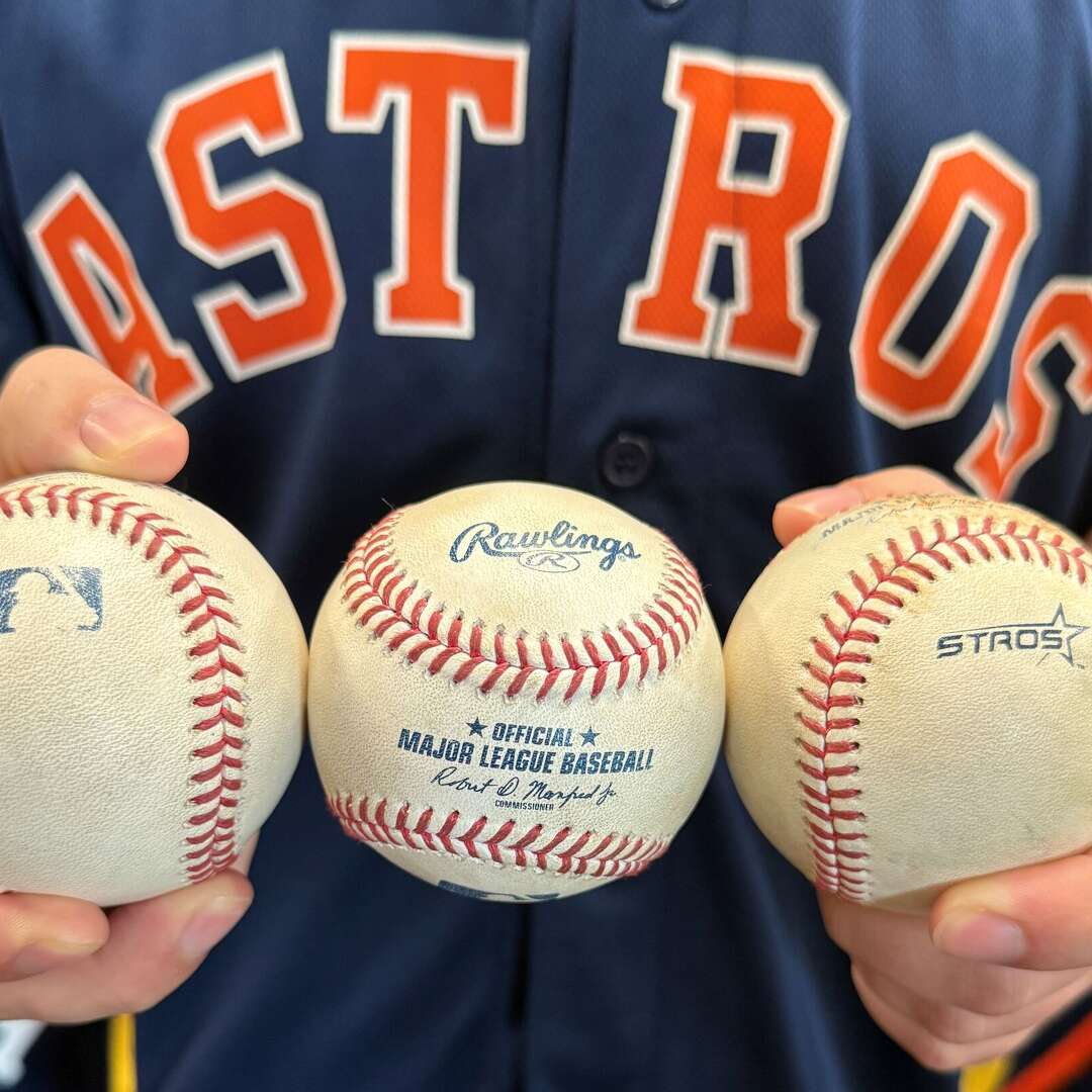 Houston Astros fan Brandon Smith with the three baseballs he caught on three straight days of the Astros-Red Sox series on March 30-April 1, 2026 at Daikin Park in Houston.