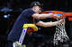 Braylon Mullins #24 of the UConn Huskies cuts down the net after defeating the Duke Blue Devils 73-72 in the Elite Eight of the 2026 NCAA Men's Basketball Tournament at Capital One Arena on March 29, 2026 in Washington, DC.