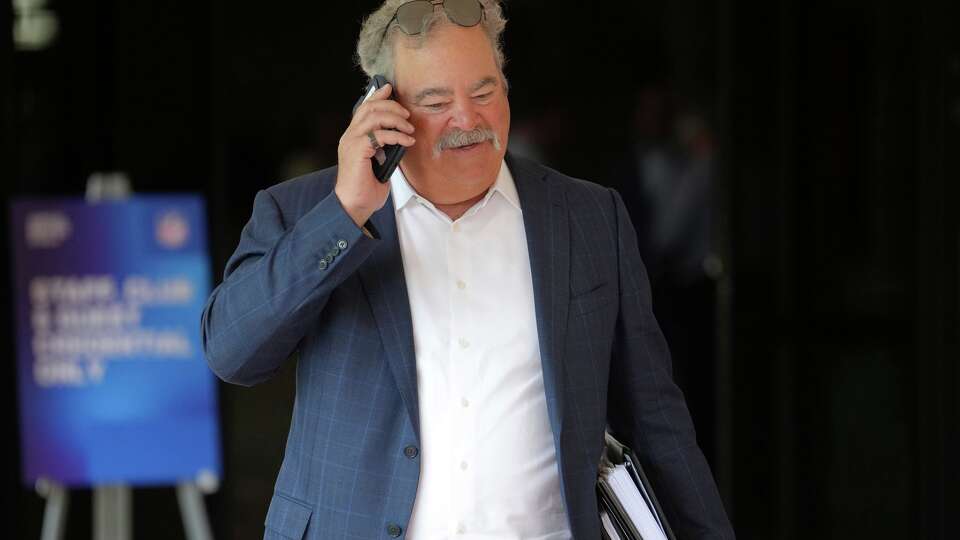 Houston Texans owner Cal McNair walks after attending a session at the NFL football annual meetings, Tuesday, March 31, 2026, in Phoenix. (AP Photo/Ross D. Franklin)