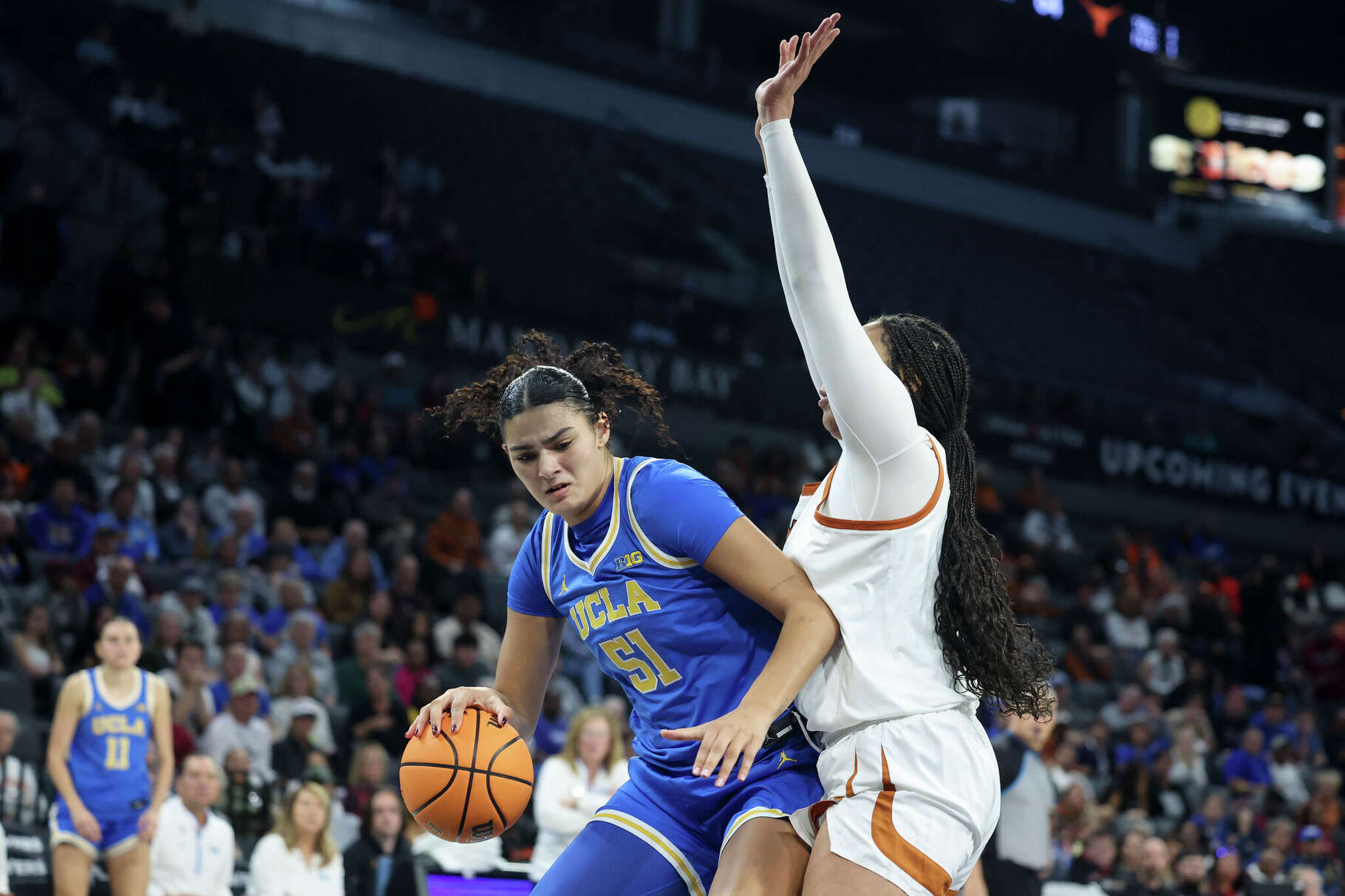 UCLA's Lauren Betts drives against Breya Cunningham of the Texas Longhorns in the fourth quarter of a Players Era Championship basketball tournament game at Michelob ULTRA Arena on November 24, 2025 in Las Vegas, Nevada.