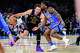 Los Angeles Lakers forward/guard Luka Dončić (77) drives against Oklahoma City Thunder guard Cason Wallace (22) during the first half of an NBA basketball game Thursday, April. 2, 2026, in Oklahoma City.
