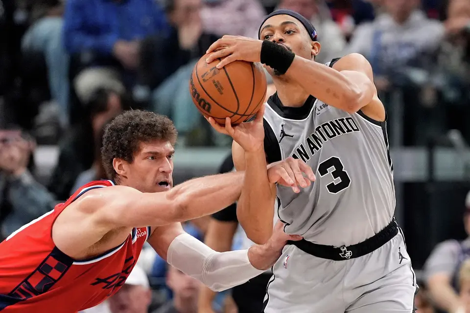 Los Angeles Clippers center Brook Lopez, left, reaches in on San Antonio Spurs forward Keldon Johnson during the second half of an NBA basketball game Thursday, April 2, 2026, in Inglewood, Calif. (AP Photo/Mark J. Terrill)