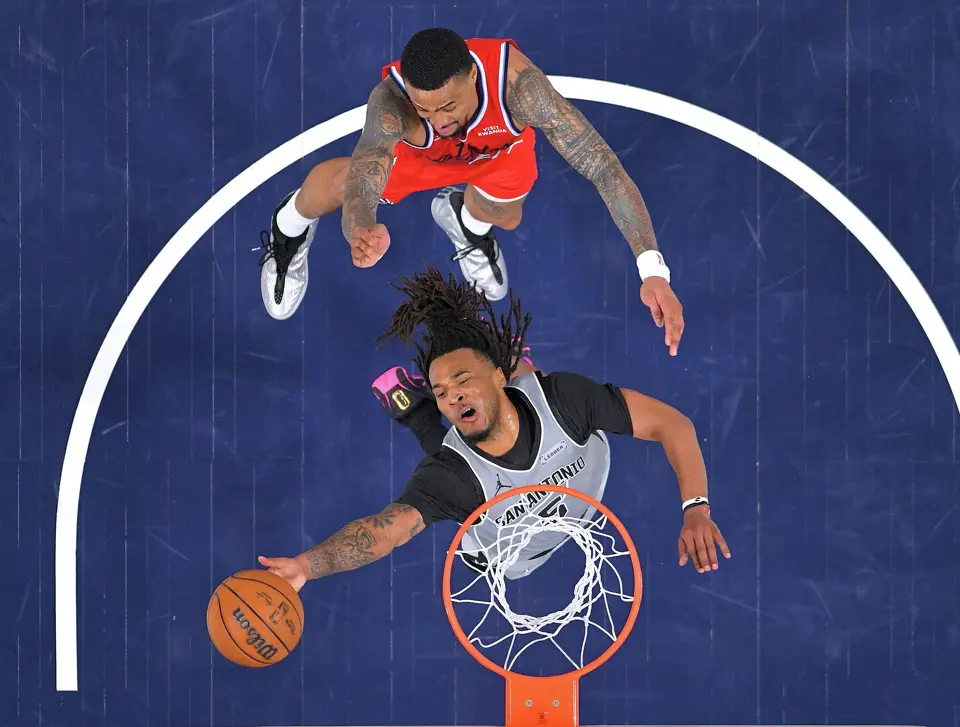 San Antonio Spurs guard Stephon Castle, below, shoots as Los Angeles Clippers forward John Collins defends during the second half of an NBA basketball game Thursday, April 2, 2026, in Inglewood, Calif. (AP Photo/Mark J. Terrill)