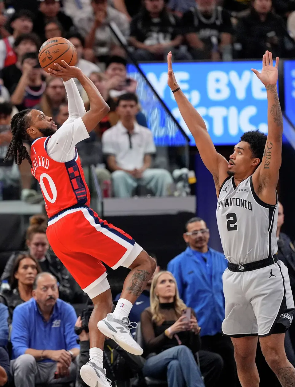 Los Angeles Clippers guard Darius Garland, left, shoots as San Antonio Spurs guard Dylan Harper defends during the first half of an NBA basketball game Thursday, April 2, 2026, in Inglewood, Calif. (AP Photo/Mark J. Terrill)