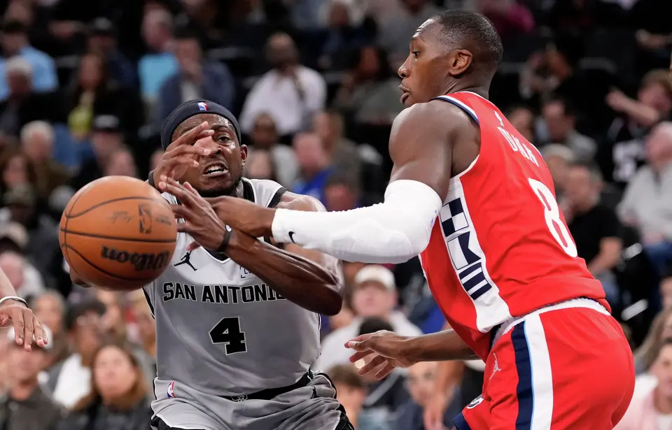 Los Angeles Clippers guard Kris Dunn, right, knocks the ball from the hands of San Antonio Spurs guard De'aaron Fox during the first half of an NBA basketball game Thursday, April 2, 2026, in Inglewood, Calif. (AP Photo/Mark J. Terrill)