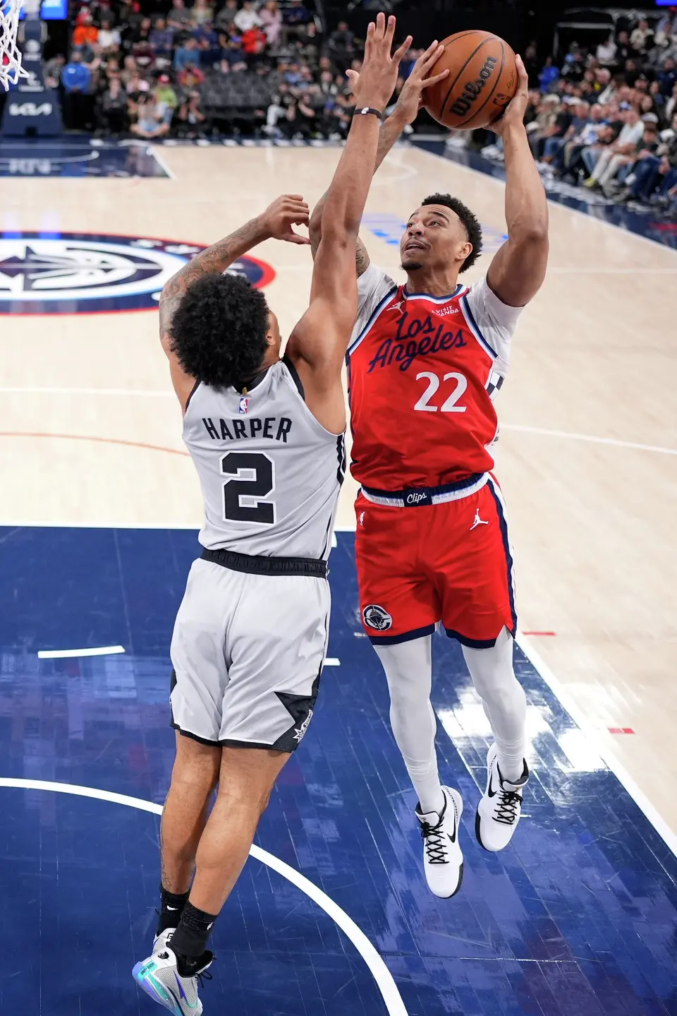 Los Angeles Clippers guard Jordan Miller, right, shoots as San Antonio Spurs guard Dylan Harper defends during the first half of an NBA basketball game Thursday, April 2, 2026, in Inglewood, Calif. (AP Photo/Mark J. Terrill)