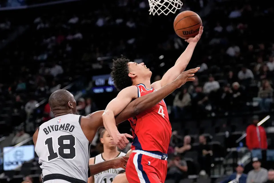 Los Angeles Clippers guard Kobe Sanders, right, shoots as San Antonio Spurs center Bismack Biyombo defends during the second half of an NBA basketball game Thursday, April 2, 2026, in Inglewood, Calif. (AP Photo/Mark J. Terrill)
