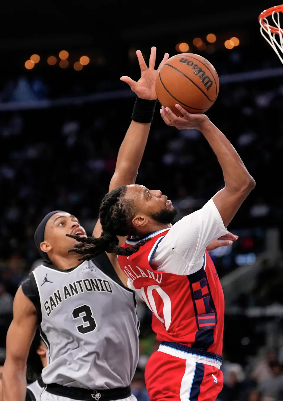 Los Angeles Clippers guard Darius Garland, right, shoots as San Antonio Spurs forward Keldon Johnson defends during the second half of an NBA basketball game Thursday, April 2, 2026, in Inglewood, Calif. (AP Photo/Mark J. Terrill)