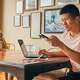 Man using a laptop at dinner table.Turbo Tax says people who rush to file their taxs may leave out important information.